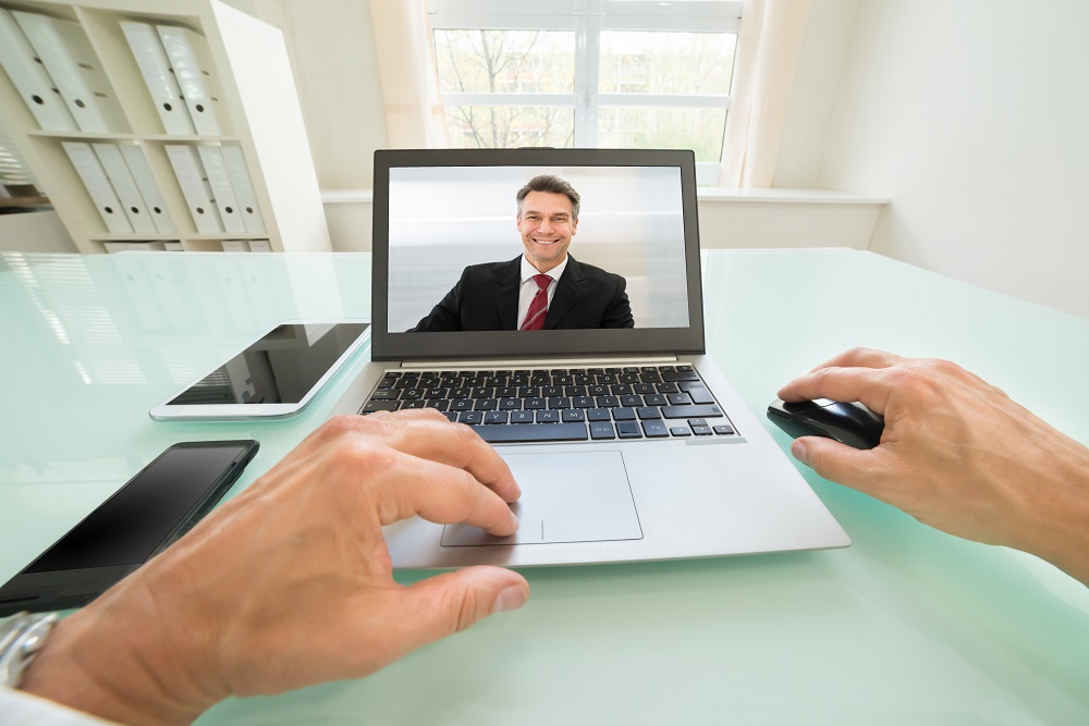 Person Having Videochat With Businessman