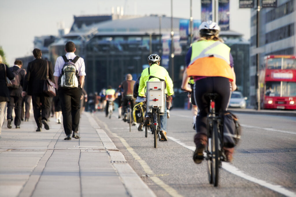 People riding their bikes and walking