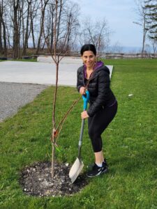 Natalie Yeadon, Impetus Co-founder/CEO, planting a cherry tree during Earth Week