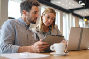 Male and female Medical Affairs colleagues communicating with their key opinion leaders and healthcare provider customers virtually, on a tablet and laptop.