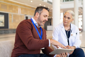 Digital transformation of Medical Affairs - male MSL meeting with a female physician, showing her the latest data on a tablet