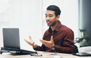 Male patient participating in an online advisory board meeting on his laptop