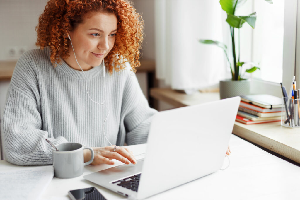 A female patient is sitting by her laptop while participating in a virtual insight-gathering program