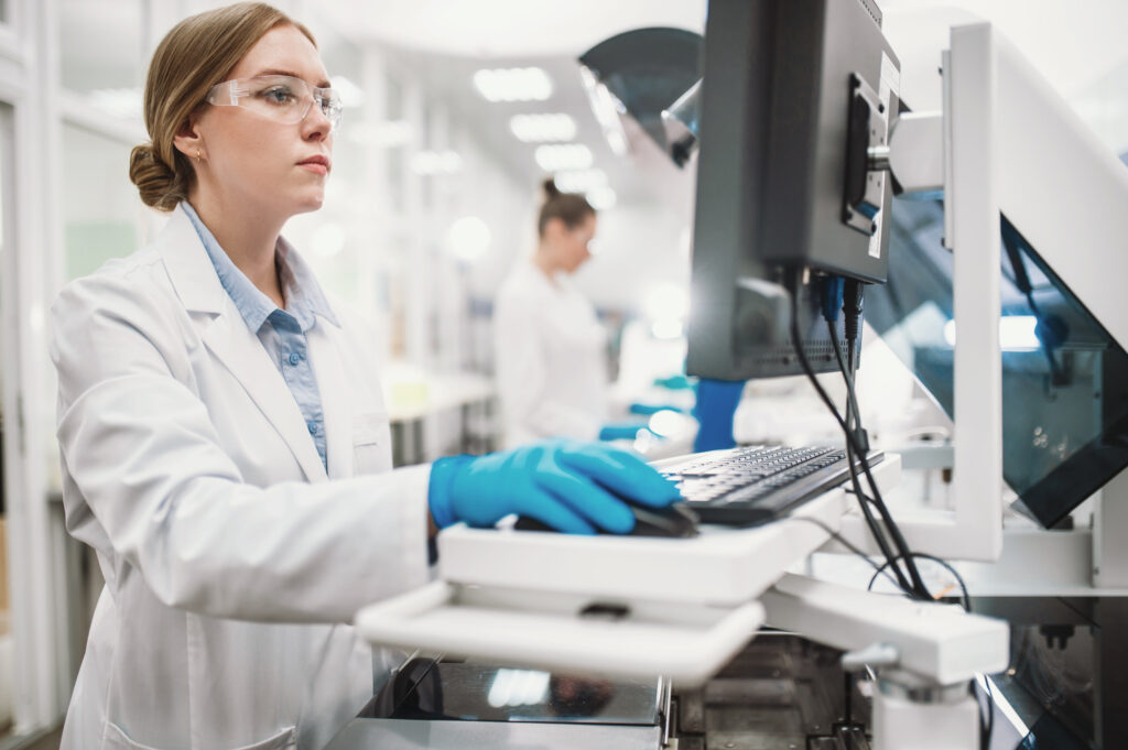 Female scientist using artificial intelligence(AI) tools on a computer to aid in her research