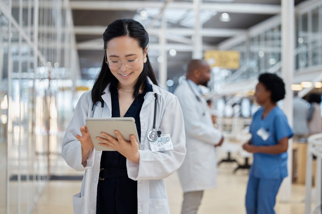 A female physicians is looking at her tablet, highlighting that the future of medical content is interactive and personalized.