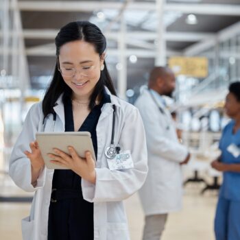 A female physicians is looking at her tablet, highlighting that the future of medical content is interactive and personalized.