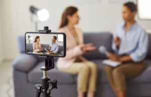 Video/podcast recording of two women sitting on a sofa. Videos and podcasts featuring patients and caregivers represent two potential ways of highlighting the patient voice.